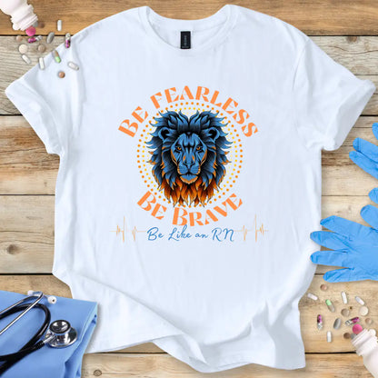White t-shirt with a lion graphic and text 'Be Fearless Be Brave Be Like an RN' on a wooden surface with medical supplies.