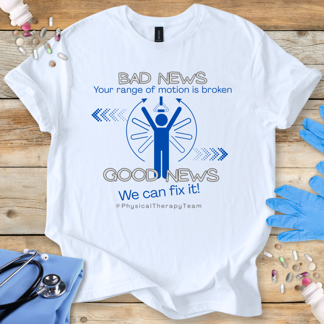 White t-shirt with a humorous physical therapy-themed graphic and 'Your range of motion is broken' text on a wooden surface with medical supplies.