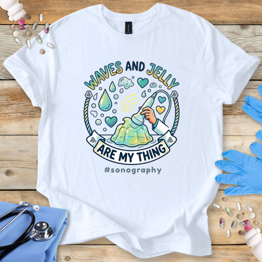 White t-shirt with 'Waves and Jelly are my thing #sonography' design on a wooden surface with medical tools.